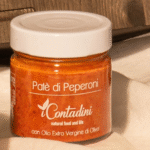 Jar of red bell pepper paté in olive oil, an artisanal product ideal for appetizers.