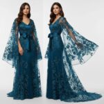 An enchanting petrol-colored tulle evening gown, adorned with floral embroidery An enchanting petrol-colored tulle evening gown, adorned with floral embroidery